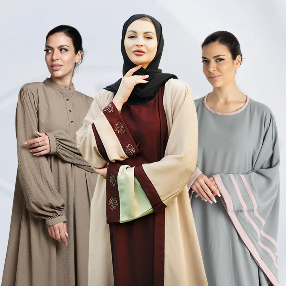Three women wearing traditional outfits with a plain background